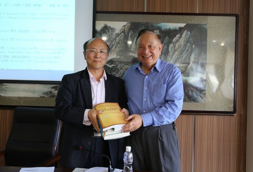 龙江医学流派传承工作室负责人、基础医学院院长姜德友代表学院接受黄柄山教授赠送的书籍