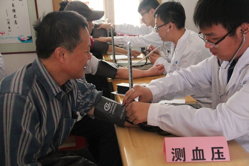 志愿者为社区居民测量血压
